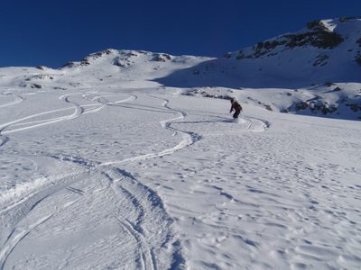 Monica snowboarding the backcountry on Catherine's splitboard.