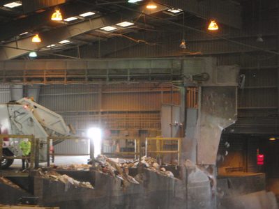 Another overhead chute brings in more trash from a...