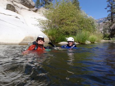 Joel and Catherine paddle down river.