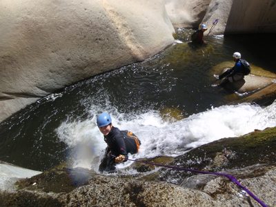 Monica hip-sliding down a bumpy mossy cascade with some...
