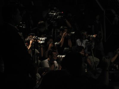 A lot of photographers were gathered for the fashion show.