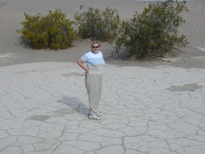 Mom on the cracked desert ground.
