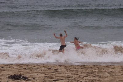 John and Tini "swim" in the Pacific Ocean.  If by "swim"...