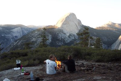 John and Tini warm themselves by the fire.