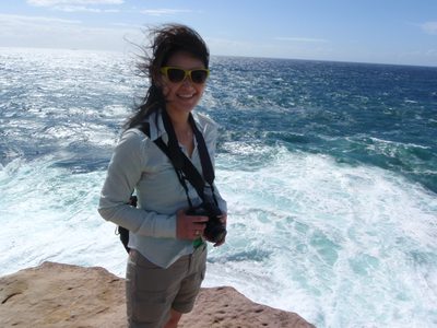 Monica standing by the coast in Bundock Park between...