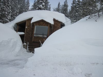 3 story house, first two stories completely covered in snow.