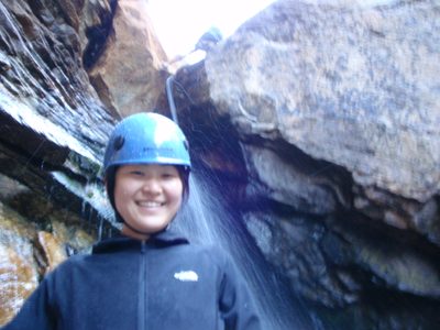 Monica, at the bottom of her first waterfall rappel. ...