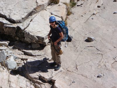 Monica, descending the ledges to the third rappel.