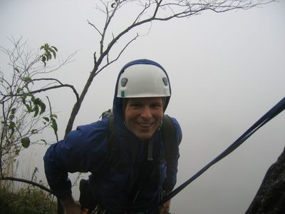 John at rappel station at the top of Minty (5.3), in the rain.