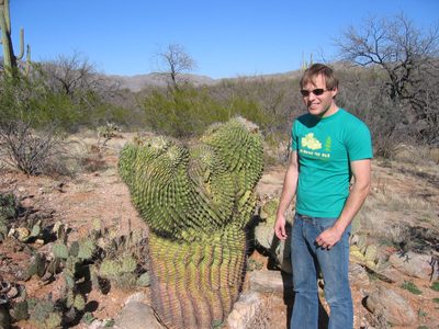John next to a weird type of saguaro that occurs in...