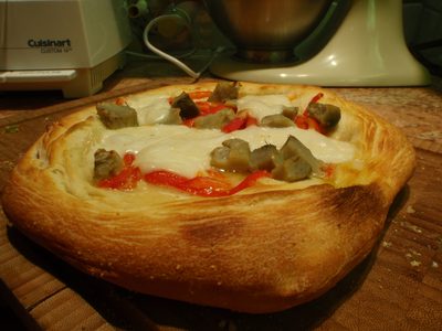 The third pizza had mozzarella cheese, roasted red...