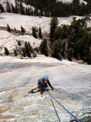 Monica, climbing over the lip of Crescent Arch (5.10b),...