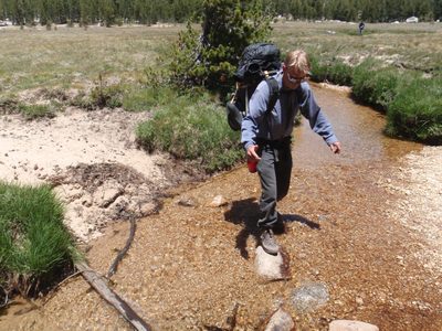 Crossing a river on tricky rocks.