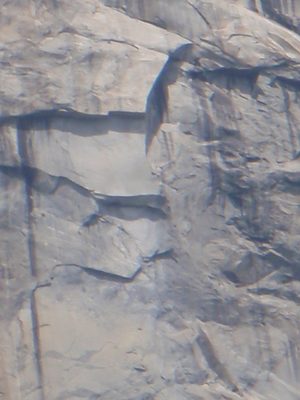 Zoomed in shot of a rope-soloist very close to the top.