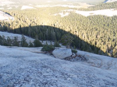 Monica finds the rappel anchors. Her head is sticking...