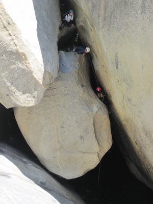 Aditi on the first rappel. Tracy and Colin watch from above.