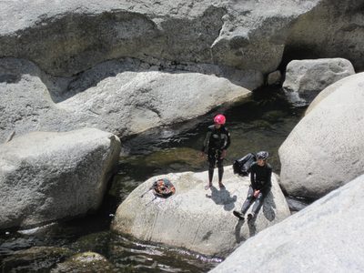 Aditi and Julia watch folks rappel down from the lunch rock.