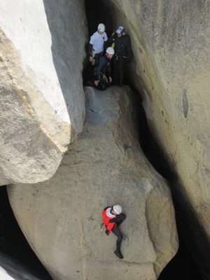 Jill on rappel. Ben, Joel and Colin watching from above.