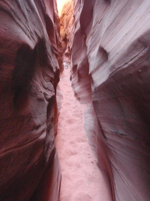 A narrow sandy slot.