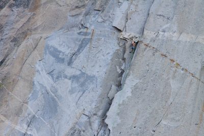 Alex, gripping what looks like an enormous chockstone...