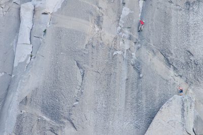 Hans leading the bolt ladder up to Boot Flake while Alex...