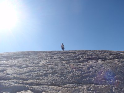 Jay walking off the back side of DAFF Dome to the rappel route.