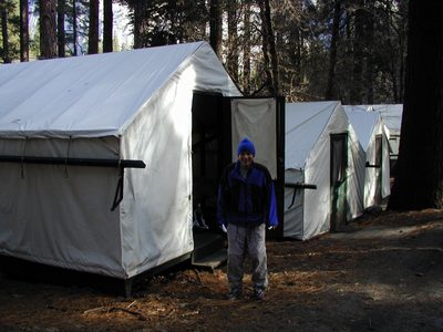 John ready to go hiking.  In front of our tent cabin in...