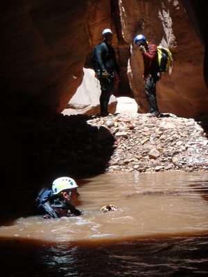 Andy swimming for shore in Pine Creek Canyon while Mike...