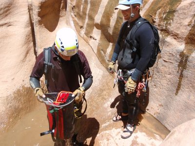 Andy and Mike wash the rope in Pine Creek Canyon. ...