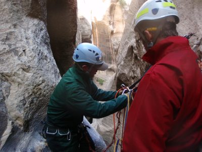 Mike rigs a locking carabiner to the anchor in a...
