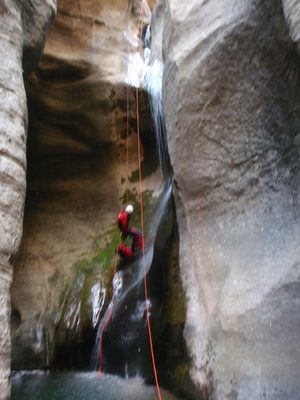 Andy getting a shower from a waterfall.  He has clipped...
