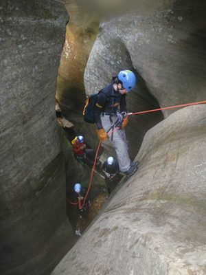 Monica on rappel while Mike gives a belay.