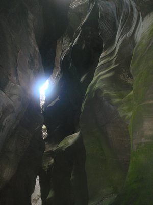 A patch of blue sky visible through the sinuous narrows.