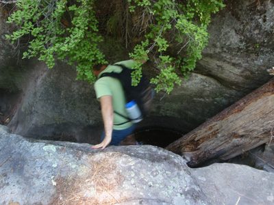 Mike, downclimbing a log in Sundance Canyon.