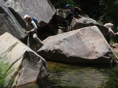 Meredith and Monica boulder-hop downstream in West Clear Creek.