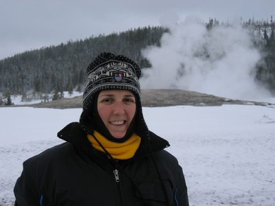Catherine in front of Old Faithful.  For one her ear...