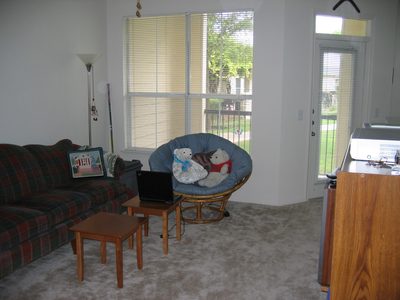 Living Room looking out over patio to grounds of complex