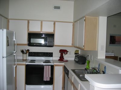 Kitchen showing off the red Kitchen Aid mixer.