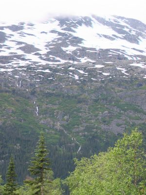 A waterfall coursing down a mountain across from where...