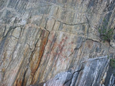 Indian pictographs on the rock face.  This is the sun...