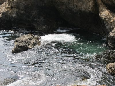 It's wierd water action.  The wave crests over the rock...