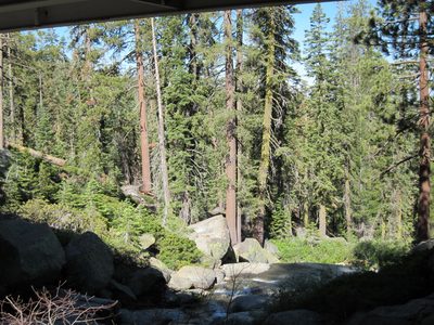 The waterfall fed a creek which coursed under the highway bridge.