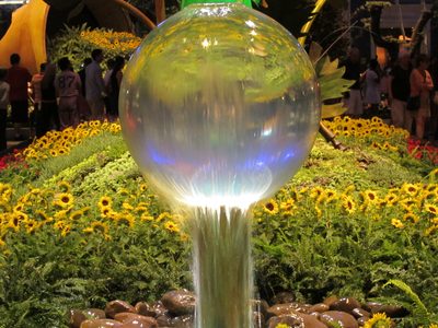 Wonderful spherical fountain in front of beds of live...