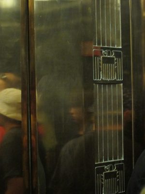 Decorative eagle flourish on the elevator door.