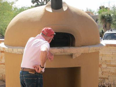 Peter inspecting the free standing "pizza oven" (and...