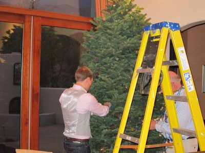 Early arrivals get to help put the lights on the tree.