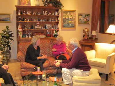 Judy Brown talkng to Taffy Eiff on the couch, with Jim...