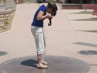 Joan getting a picture of her feet in four states 