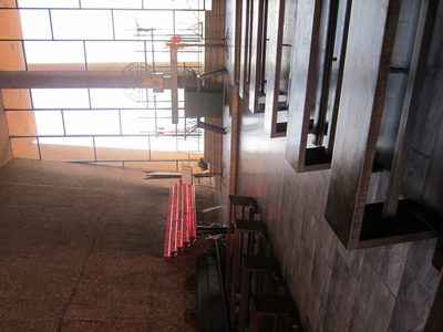 Inside the church.  Hard to pick out, but the pew side...