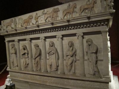 On the reverse side, six weeping women mourning the loss...